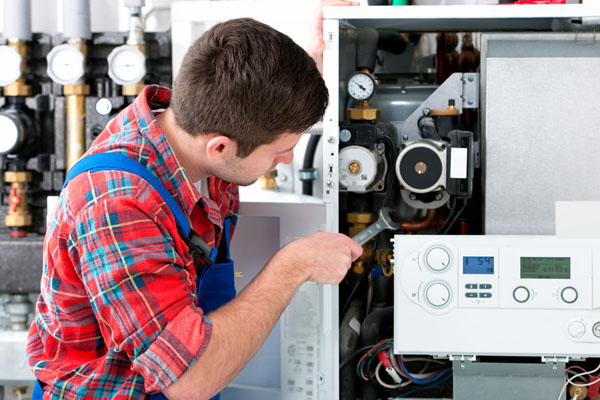 HVAC technician inspecting an indoor heating system in Golden, CO