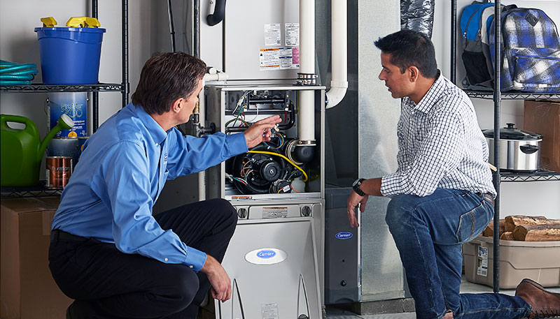 HVAC technician evaluating a furnace for repair or replacement in Golden