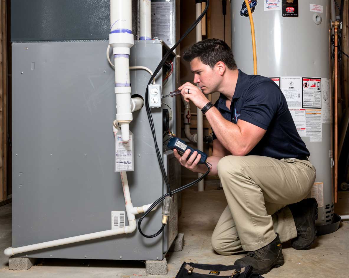HVAC technician performing a furnace tune-up in Golden